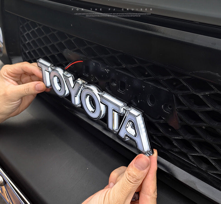 FJ Cruiser LED Luminous Grille Logo – Illuminated Front Emblem Toyota Letter Badge (Fits 2007–2023)